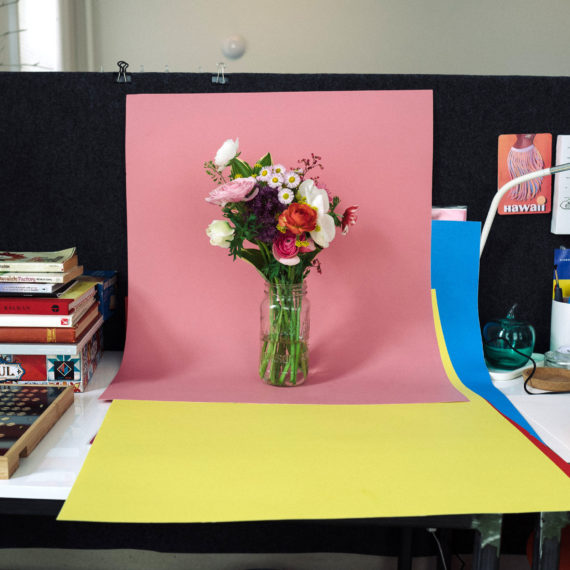 A bouquet of flowers on a pink sheet of poster board