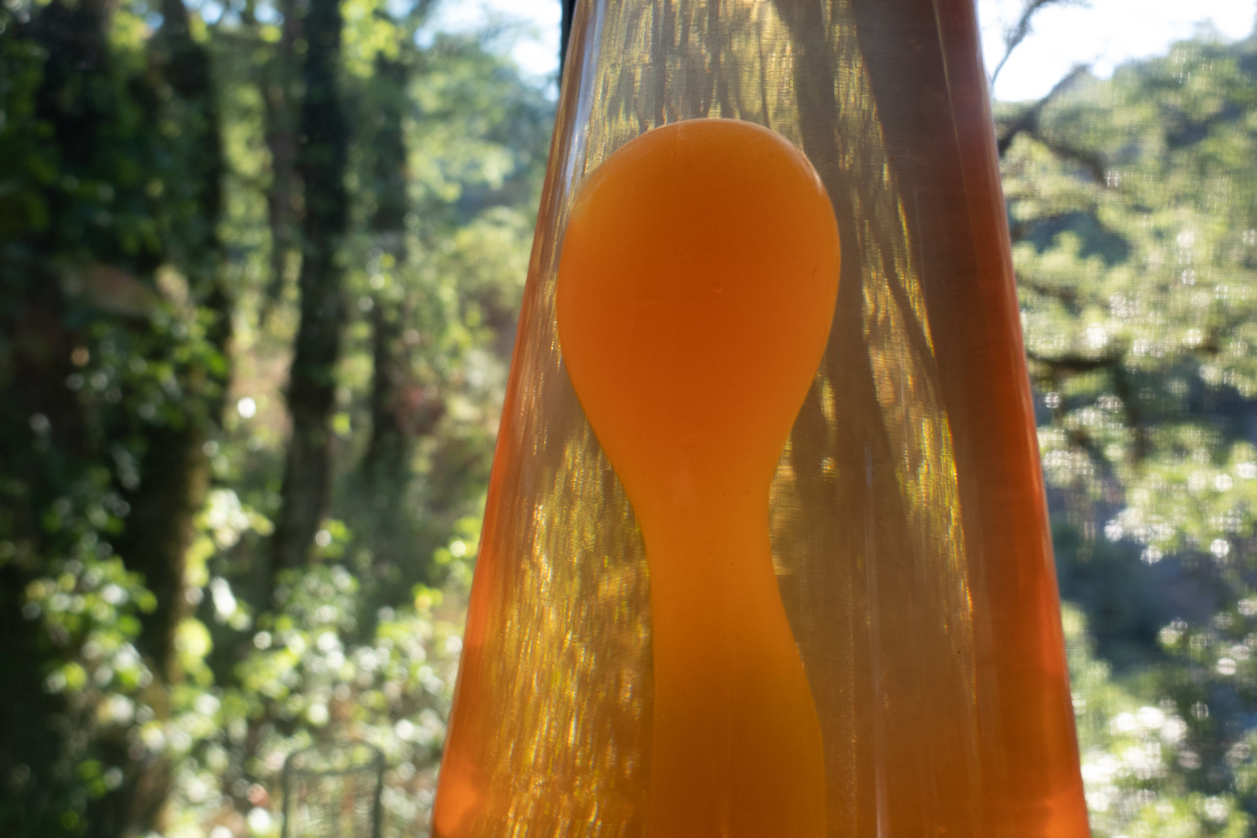 A lava lamp in front of a window