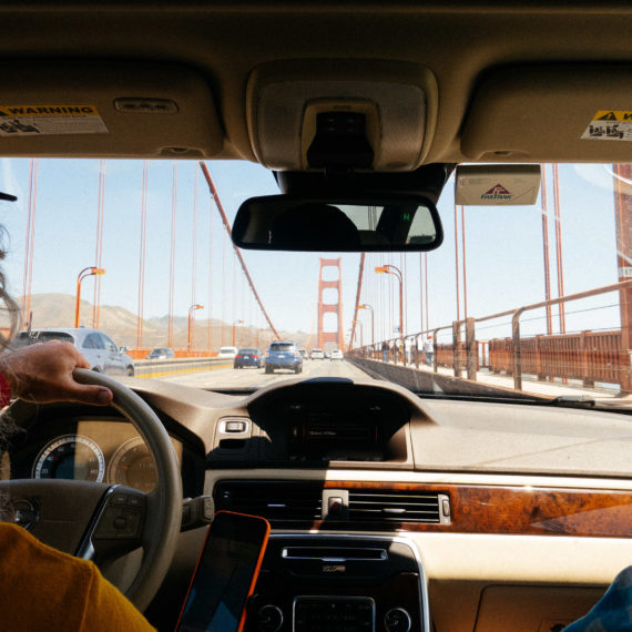 Looking through the windshield of a car driving across the Golden Gate bridge