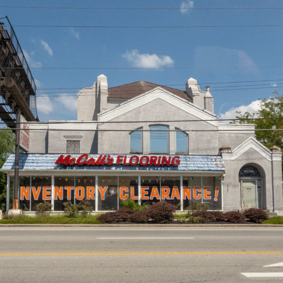 Flooring building with an inventory clearance sign in the window