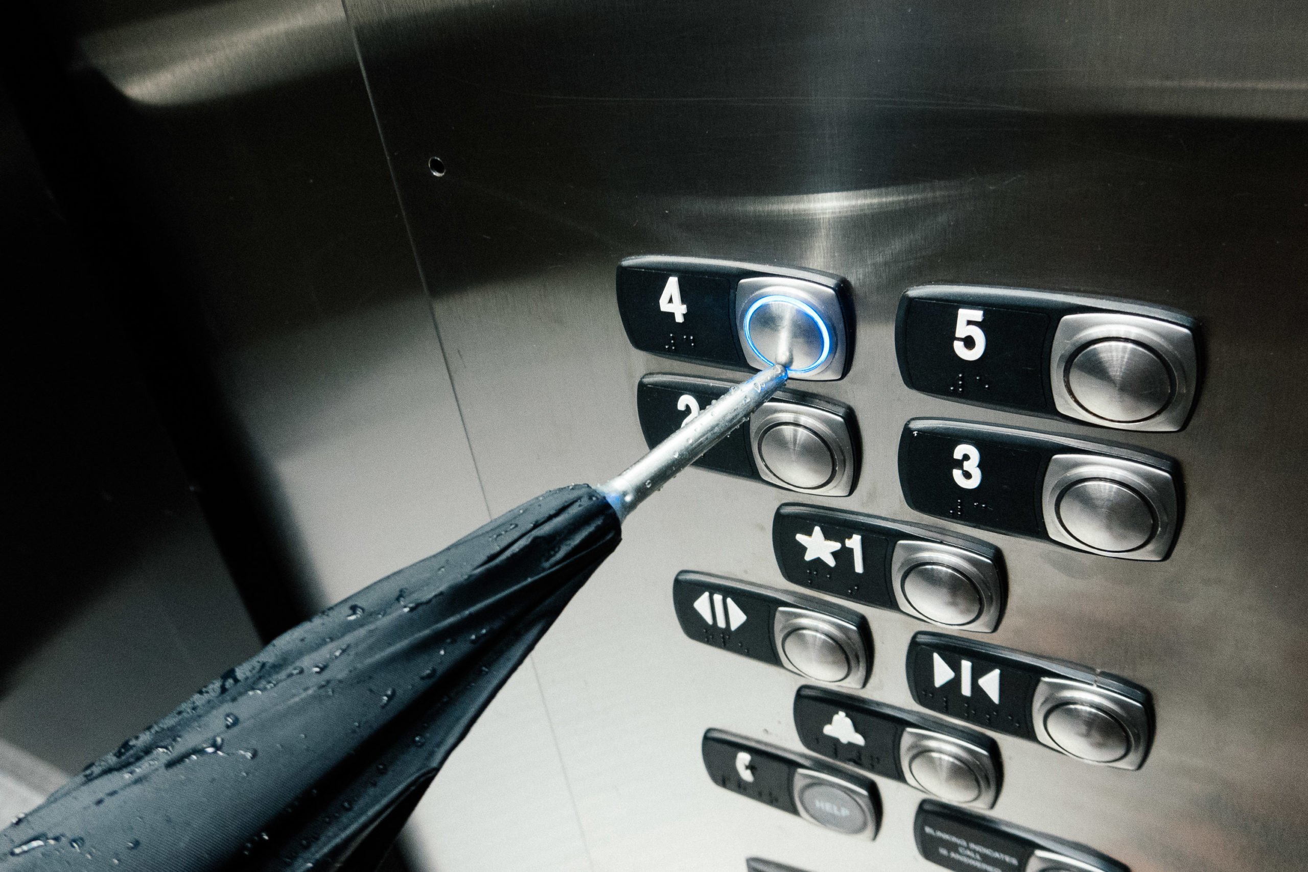 Using an umbrella to push the elevator button