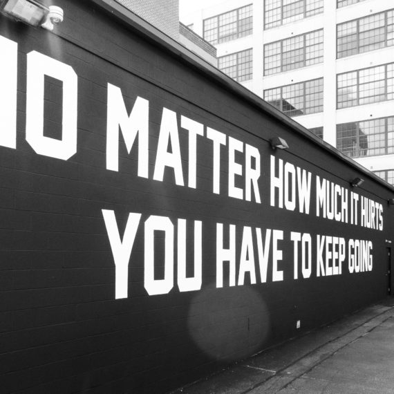 A mural made of white letters on a black wall