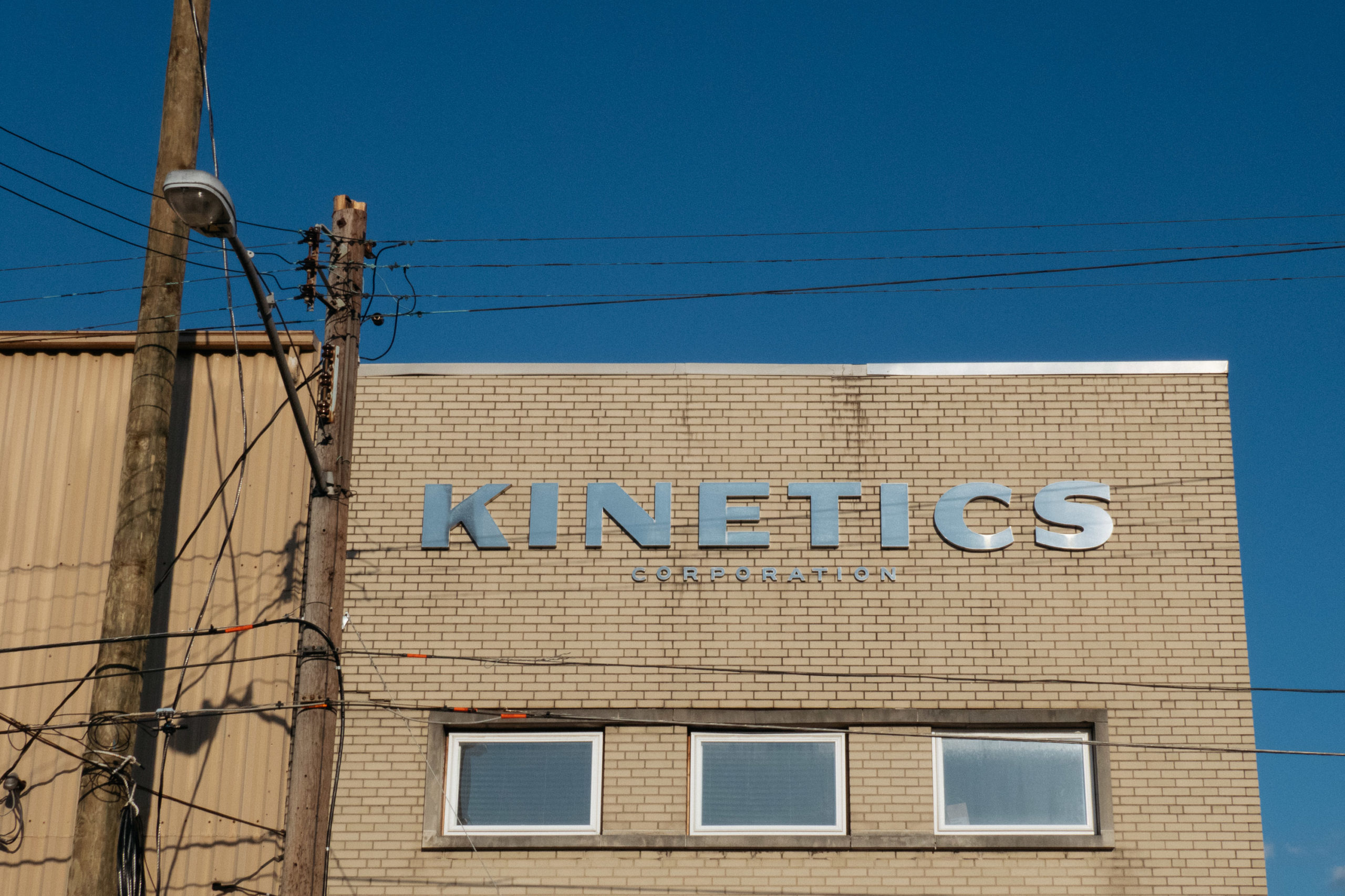 A building with the word KINETICS in metallic letters on the side