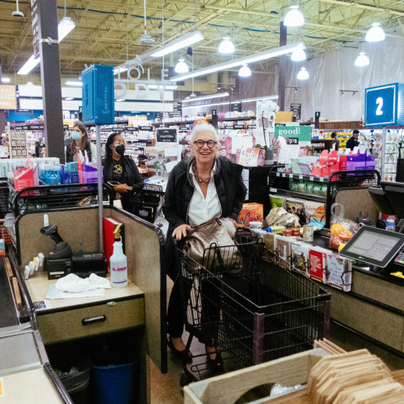 A woman at a checkout in a grocery store