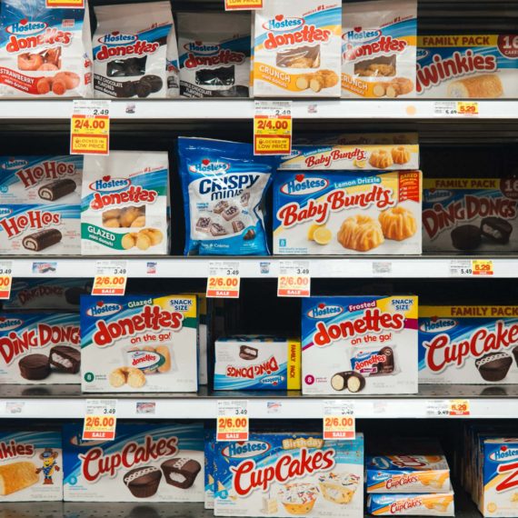 Grocery shelves filled with Hostess products including Twinkies, Ding Dongs, HoHos, Zingers, Snoballs, donuts, cupcakes and more.