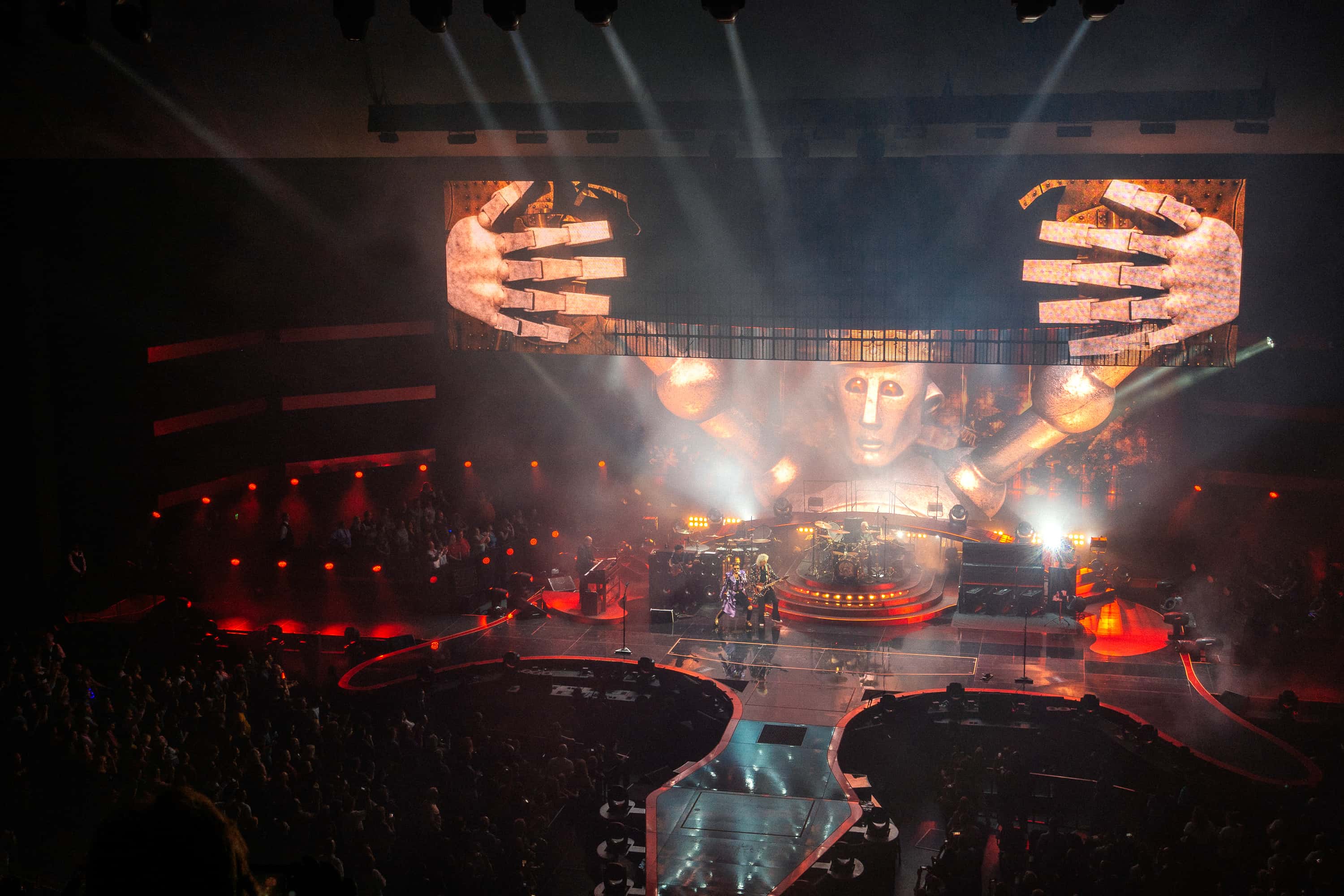 Rock stage with the band queen, smoke, lights and a large robot on the big screen