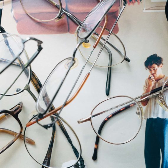 A jumble of eyeglasses on the cover of a record with a man looking perplexed