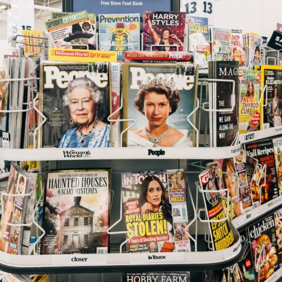 Topical magazines that have taken over the displays of tabloids at a grocery store checkou