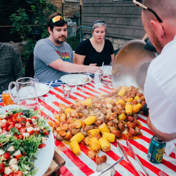 A seafood boil is poured onto a tablecloth