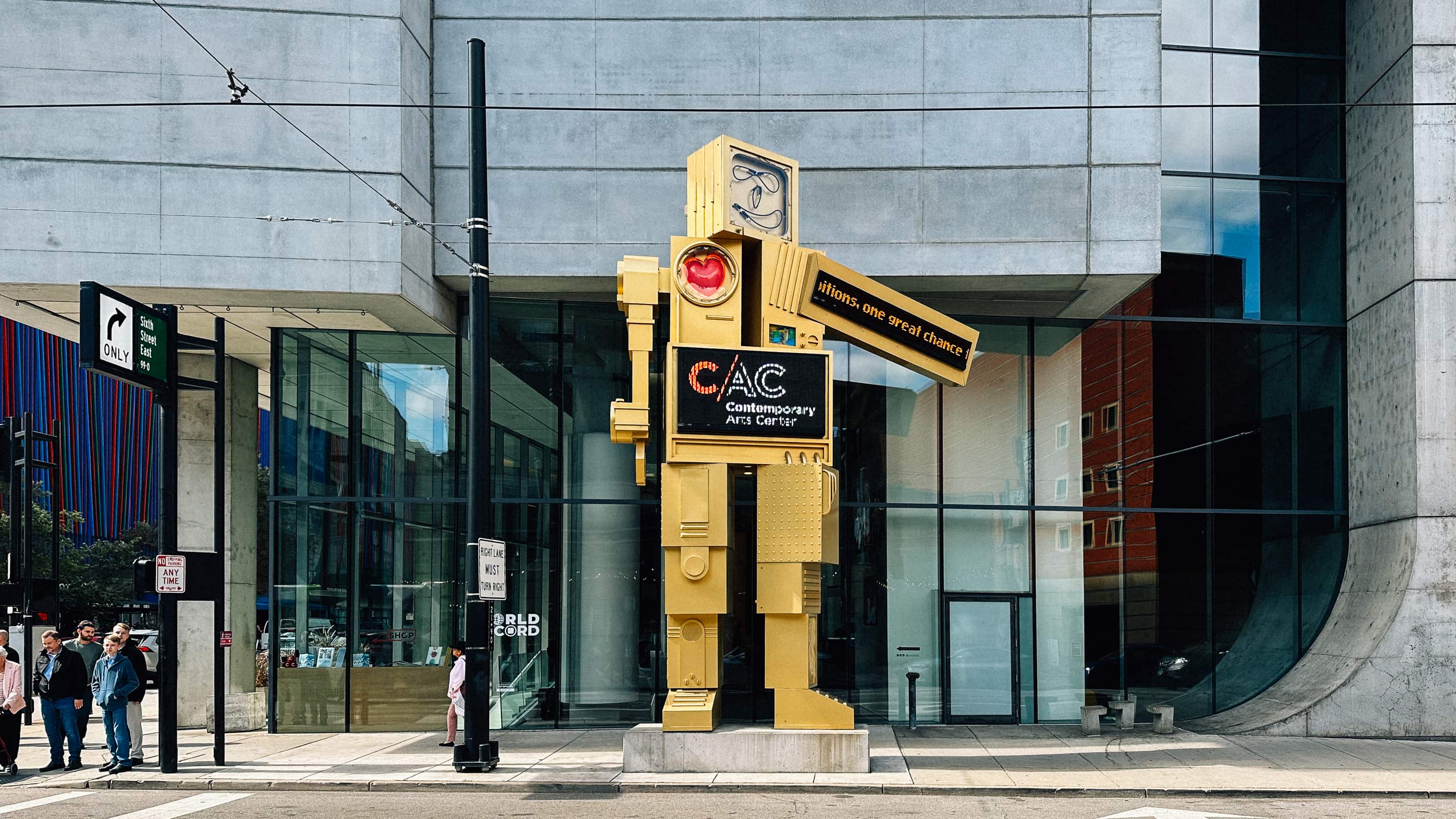 A robot sculpture with screens outside of the Cincinnati contemporary art museum