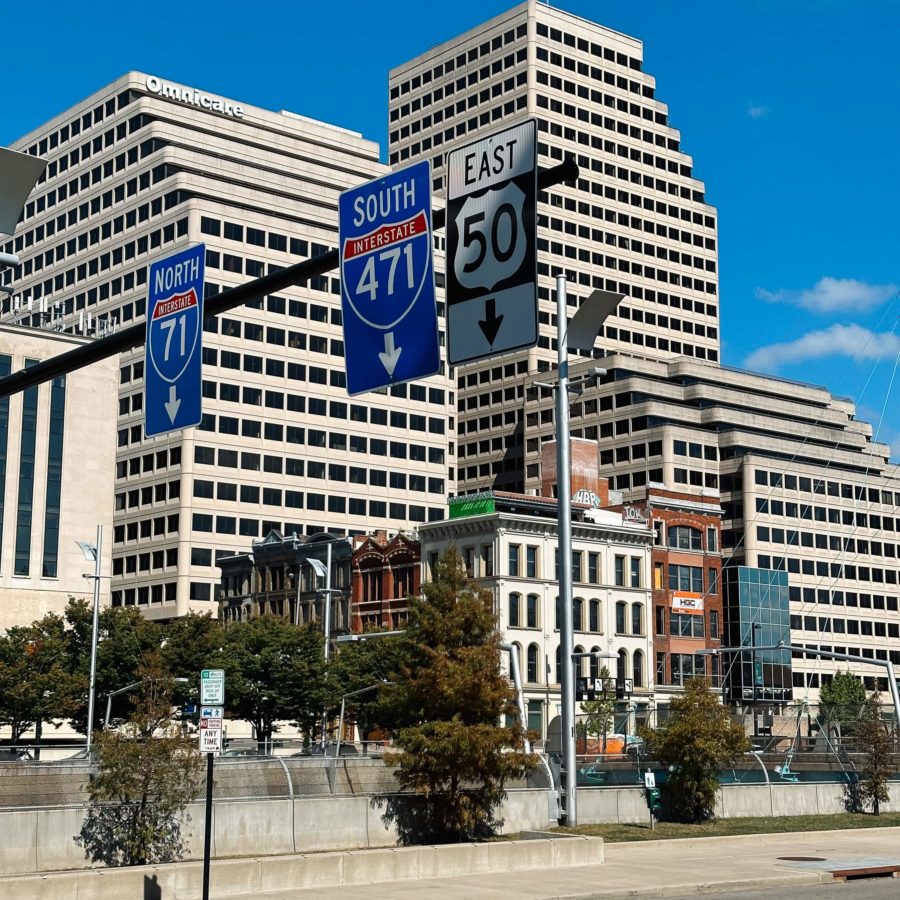 Highway signs in front of city buildings old and new