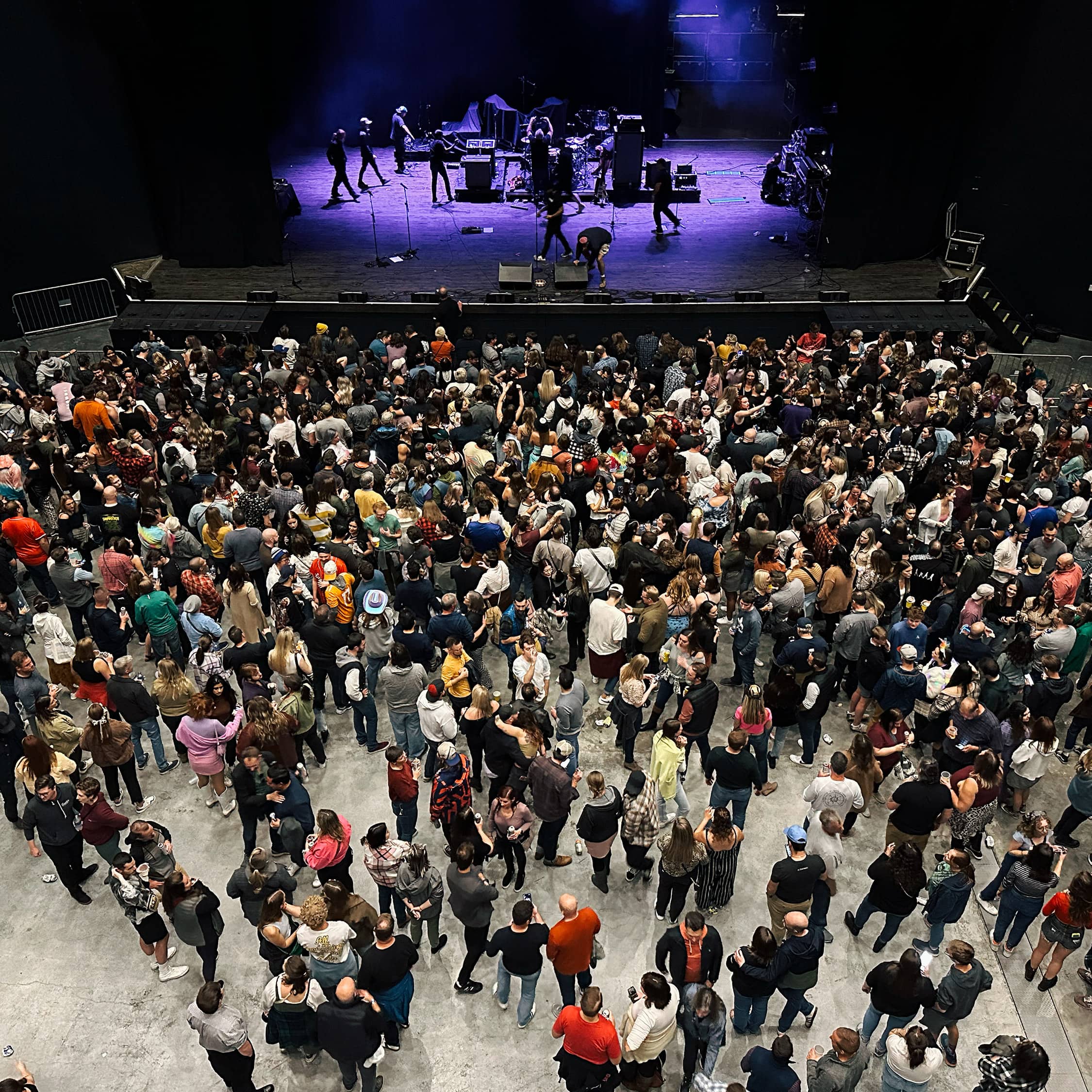 A crowd gathers in a concert venue