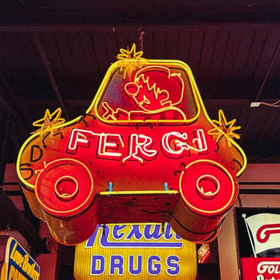 A neon sign of a car that says FERGI