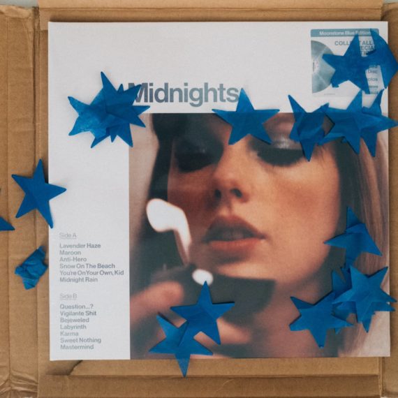 Taylor Swift’s Midnights on vinyl in a shipping box with blue tissue paper stars