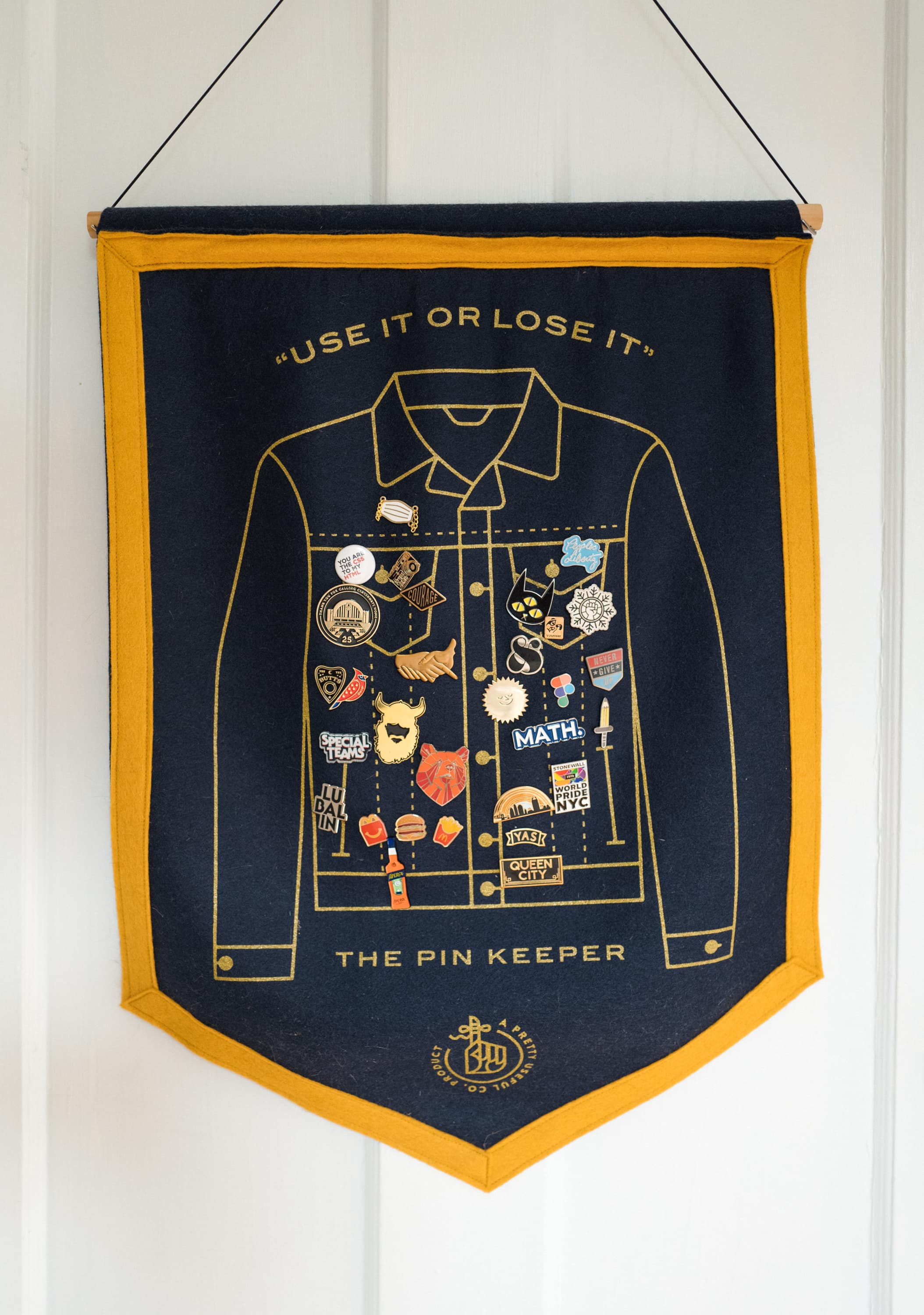 A felt banner with a screen print of a jean jacked to use for displaying a pin collection