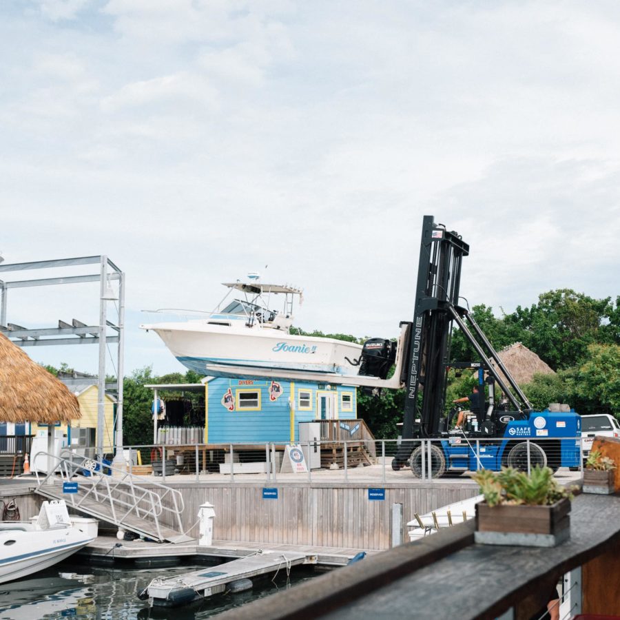 A boat forklift transporting a boat called the Joanie II