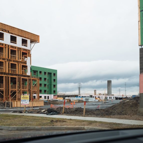 Buildings under construction with an elevator shaft in the distance