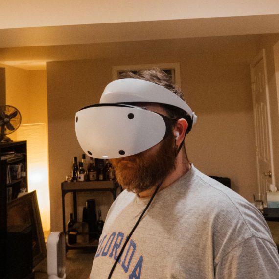 A bearded man wears a VR headset