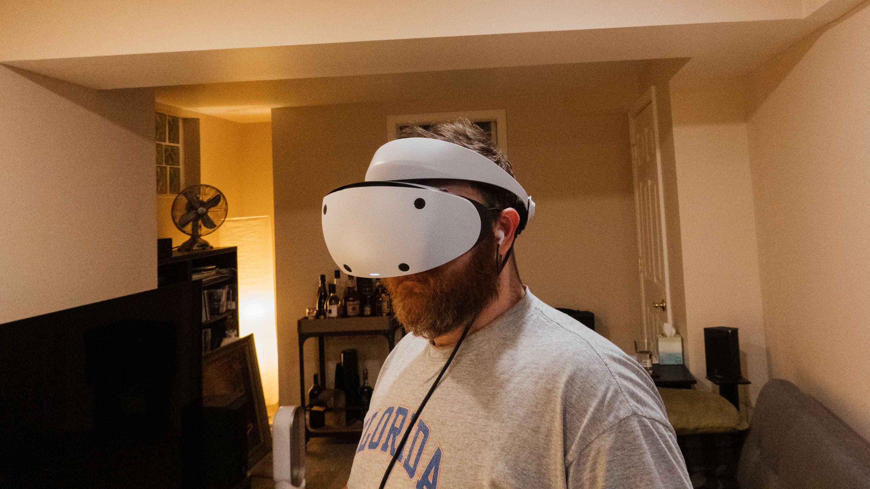 A bearded man wears a VR headset