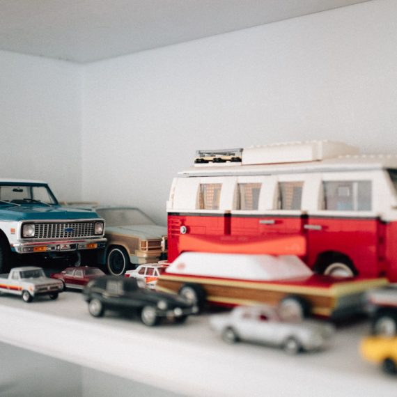 Scale model of a Chevy Blazer on a shelf with other various size scale models of vehicles