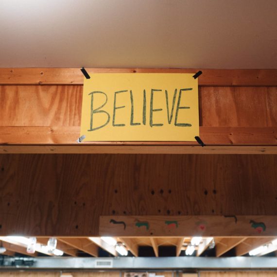 BELIEVE sign in a workshop