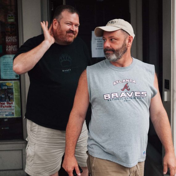 Two men exit an ice cream shop