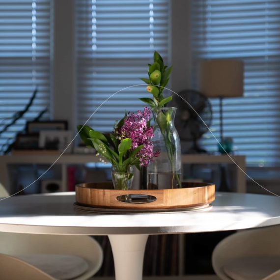 A small vase filled with Lilacs and Lily of the Valley on a table