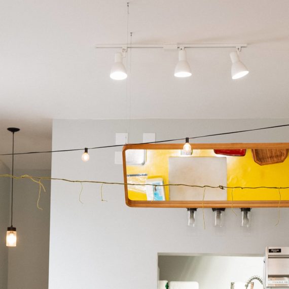 Mirror above yellow table used for cooking demonstrations