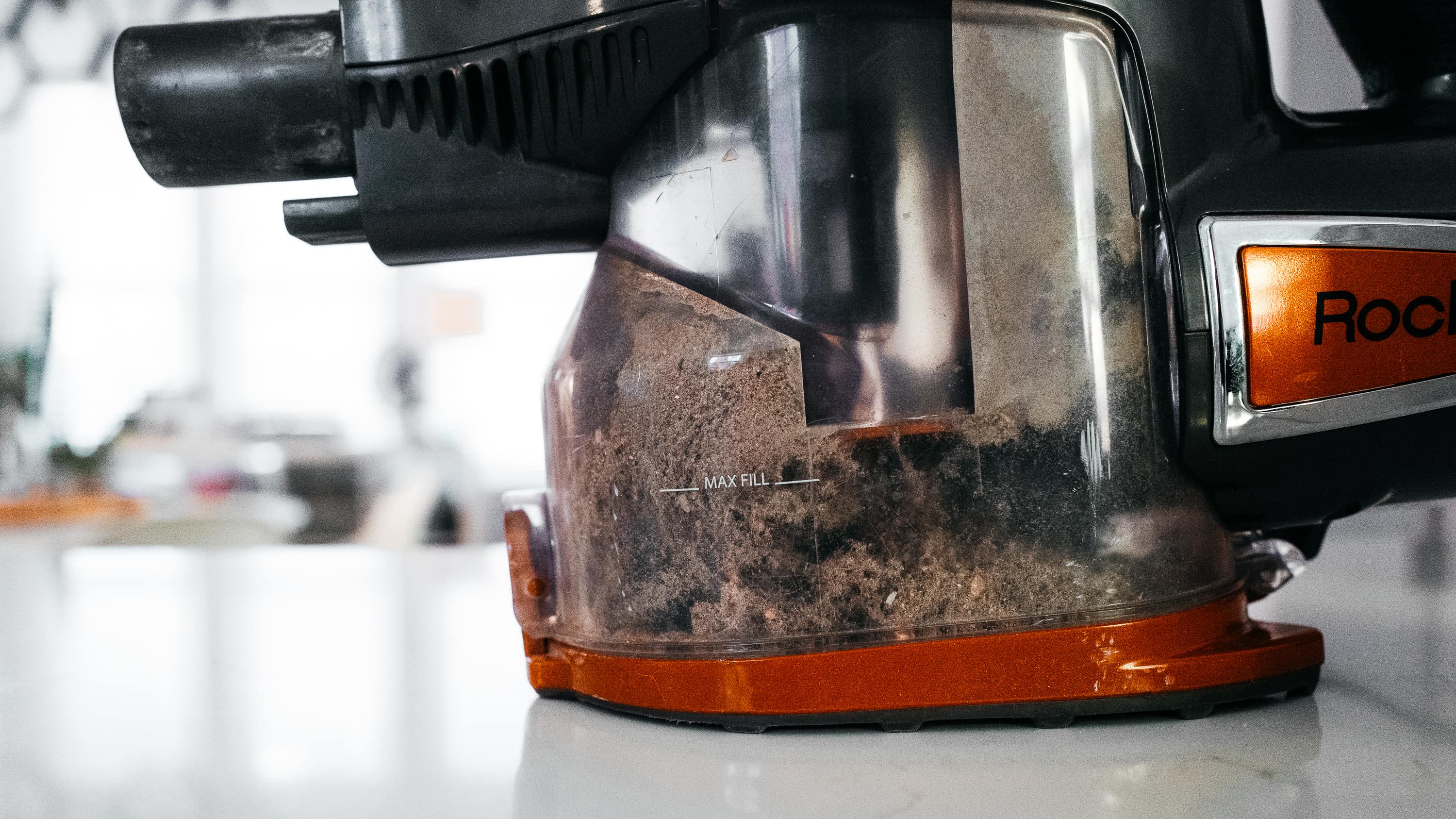 Corded stick vacuum chamber filled with dust and pet hair