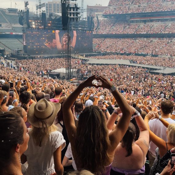 Fans make signs of heart with hands at Taylor Swift Eras Tour stop in Cincinnati