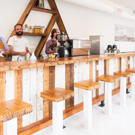 A bright white bar restaurant with triangular decor