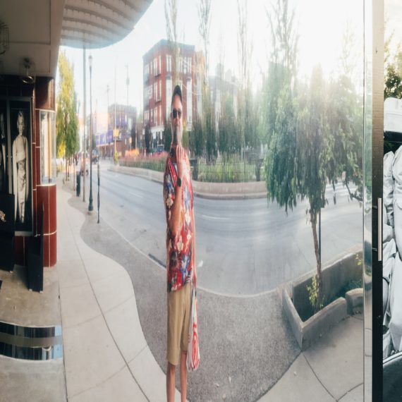 Man reflected in curved surface that makes him look skinny