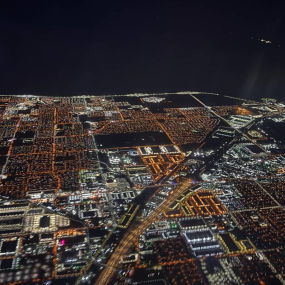 Vegas as seen from above at night. Lights from the outlying suburbs end and the vast darkness of the desert begins