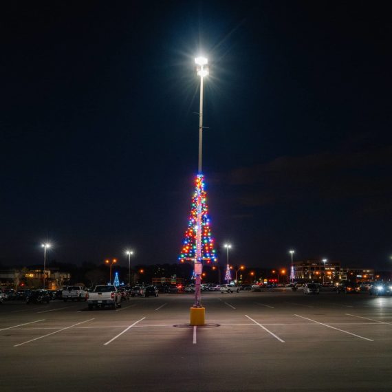 Parking lot light fixture decorated like a Christmas tree