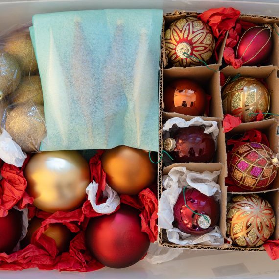 Ornaments in plastic storage bin and wine box