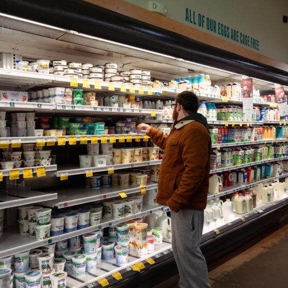 Man selects yogurt at Whole Foods Market