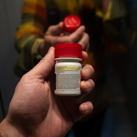 Person holding a bottle of Tylenol PM