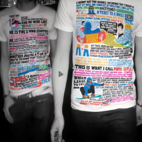 Two persons with t-shirts on that have lots of designed text