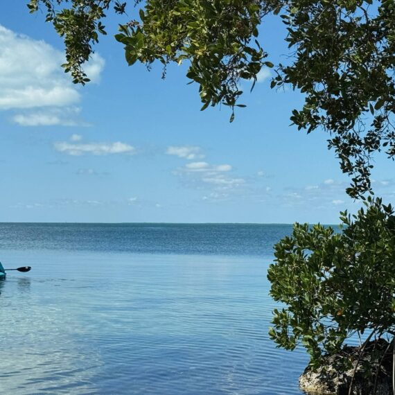 Three figures kayak in the Florida Bay in the Keys