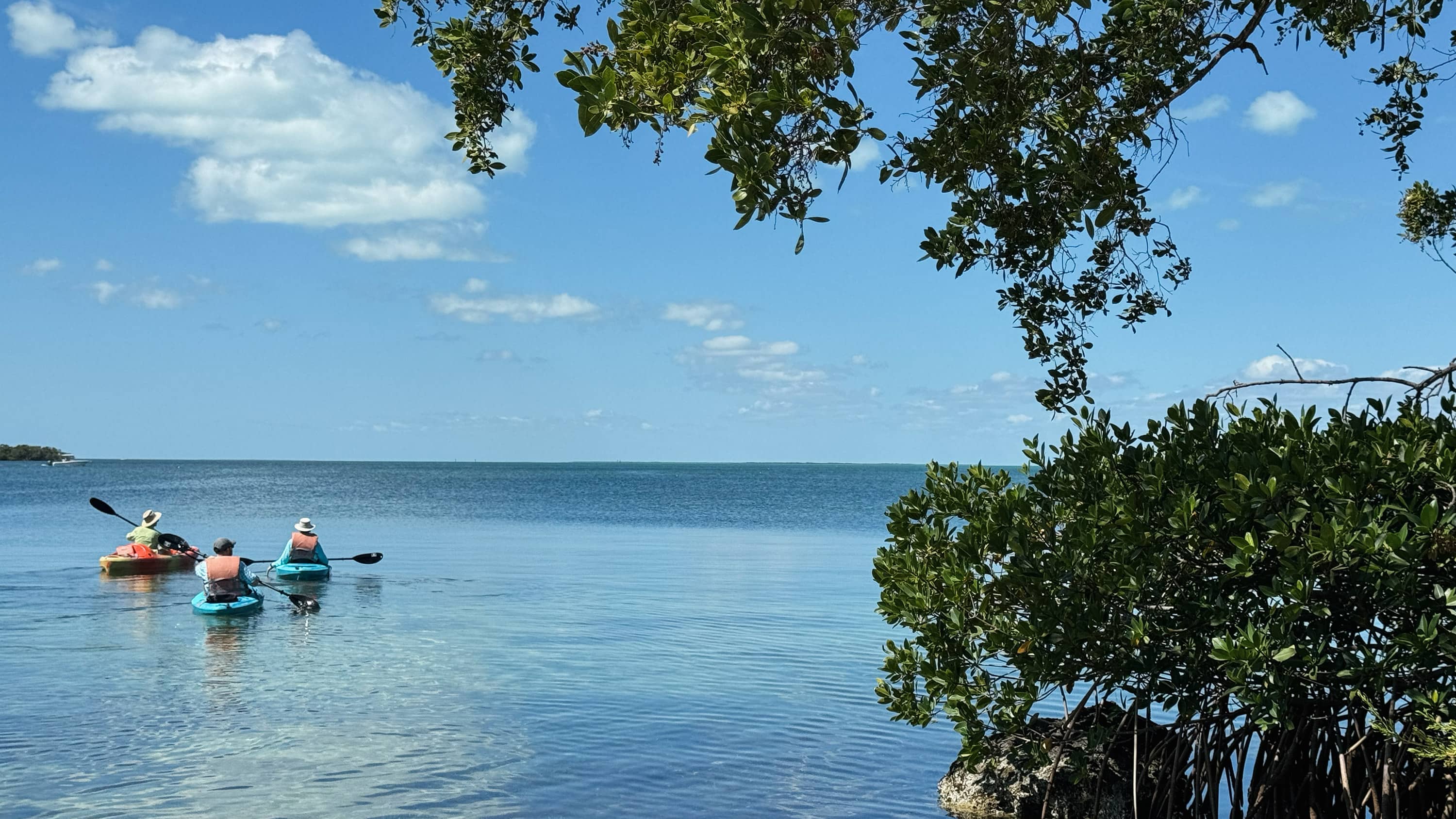 Three figures kayak in the Florida Bay in the Keys