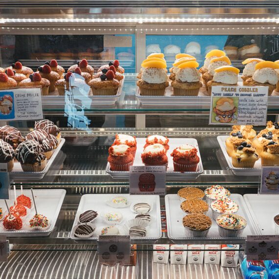 A display case filled with cupcakes