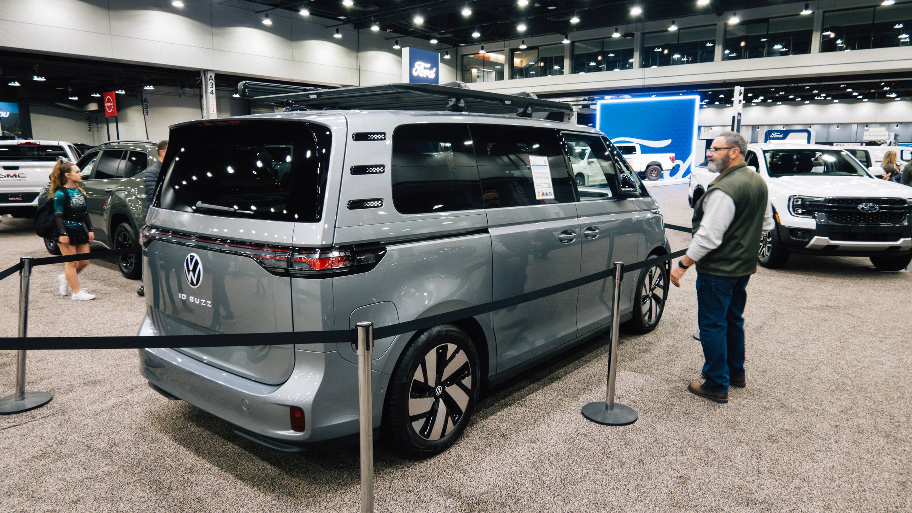 Man looks at roped off VW ID Buzz at an auto show