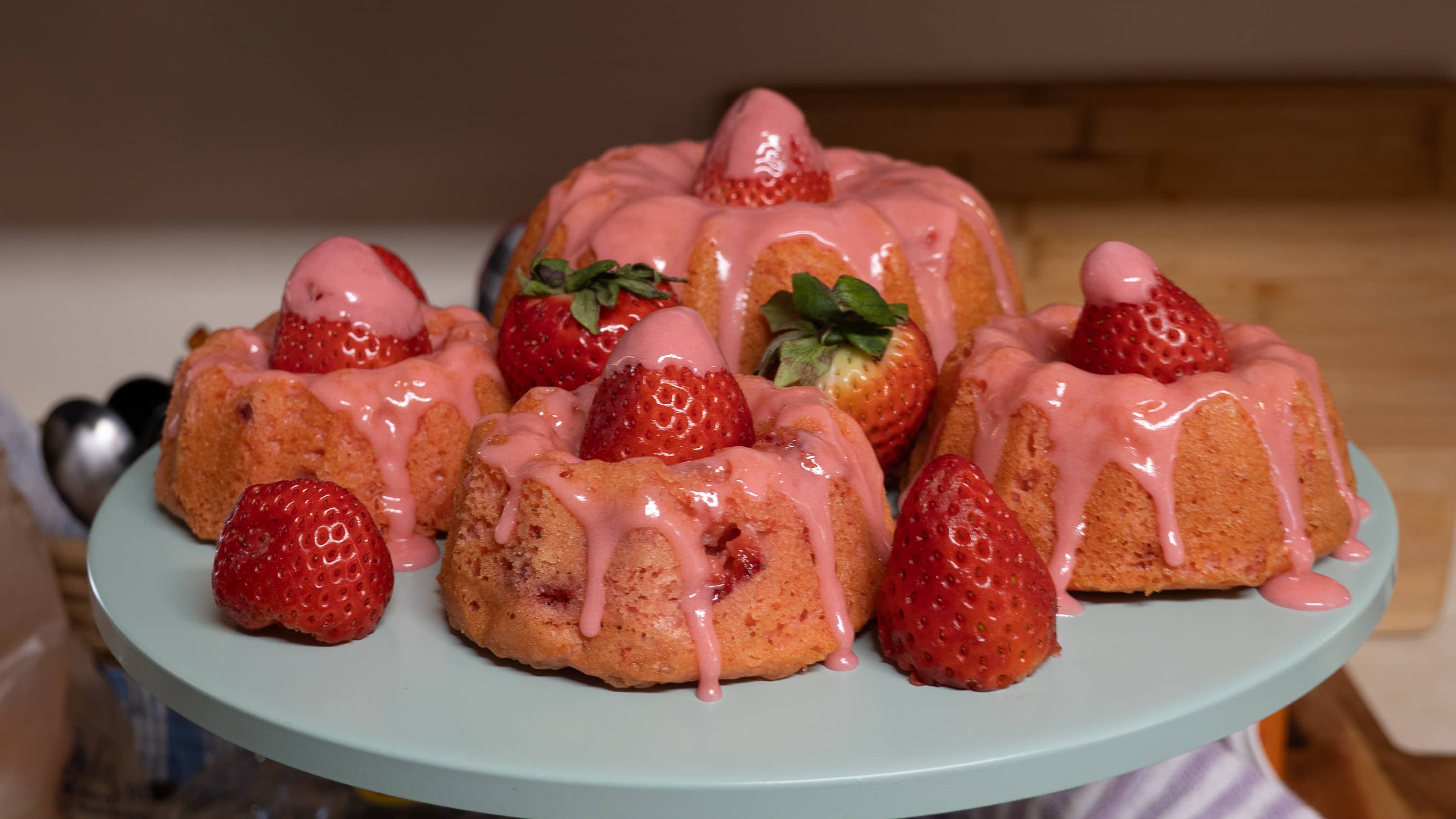 A serving plate full of strawberries and strawberry cakes