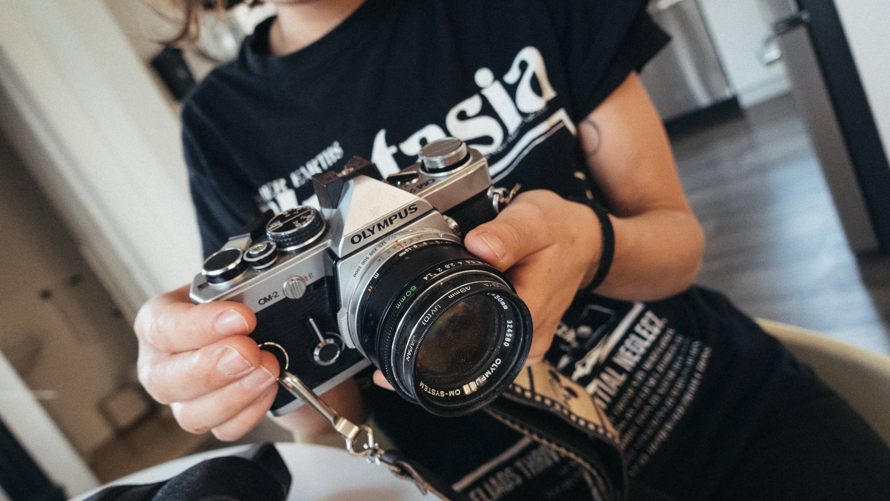 Person holding Olympus film camera